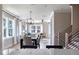 Bright and airy dining room featuring a modern chandelier and views into the living room and staircase at 2013 Trident Maple Ln, Chapel Hill, NC 27517