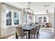 Bright and airy dining room featuring a modern chandelier and views of the wooded landscape at 2013 Trident Maple Ln, Chapel Hill, NC 27517