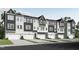 New construction townhomes, each with a two-car garage and modern exterior in a neutral color palette at 2013 Trident Maple Ln, Chapel Hill, NC 27517