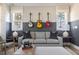 Stylish living room with guitar decor and large picture windows with views of the surrounding nature at 2013 Trident Maple Ln, Chapel Hill, NC 27517