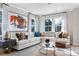 Bright living room featuring a large sectional sofa, area rug, and abundant natural light from the surrounding windows at 2013 Trident Maple Ln, Chapel Hill, NC 27517