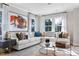Bright living room featuring a large sectional sofa, area rug, and abundant natural light from the surrounding windows at 2013 Trident Maple Ln, Chapel Hill, NC 27517