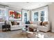 Bright living room featuring a large sectional sofa, area rug, and abundant natural light from the surrounding windows at 2013 Trident Maple Ln, Chapel Hill, NC 27517