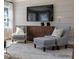 Comfortable living room featuring an entertainment center, hardwood floors, and natural lighting at 2013 Trident Maple Ln, Chapel Hill, NC 27517