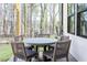 Outdoor patio area with a round table and four chairs, perfect for enjoying the backyard views at 2013 Trident Maple Ln, Chapel Hill, NC 27517