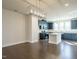 Modern kitchen with dark cabinets, stainless steel appliances, a white island, and hardwood floors at 2019 Trident Maple Ln, Chapel Hill, NC 27517