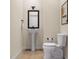 Powder room featuring a pedestal sink, framed mirror, and modern fixtures at 2021 Trident Maple Ln, Chapel Hill, NC 27517