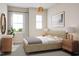 Neutral bedroom features natural light, light tan colored walls, carpet, and woven light fixture at 2021 Trident Maple Ln, Chapel Hill, NC 27517