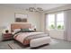 Bedroom showcasing large windows, contemporary decor, and a comfortable bed with bench at 2021 Trident Maple Ln, Chapel Hill, NC 27517