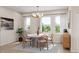 Bright dining area with a round table and views from large windows at 2021 Trident Maple Ln, Chapel Hill, NC 27517
