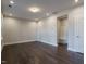 Spacious and bright flex room with dark hardwood flooring and recessed lighting at 2021 Trident Maple Ln, Chapel Hill, NC 27517