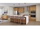 Stylish kitchen with an island, stainless steel appliances, and warm wood cabinetry at 2021 Trident Maple Ln, Chapel Hill, NC 27517