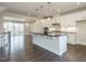 Open kitchen features stainless appliances, white cabinets, granite countertops, and island with seating at 2021 Trident Maple Ln, Chapel Hill, NC 27517