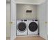 Laundry room with side by side washer and dryer and wire shelving at 2021 Trident Maple Ln, Chapel Hill, NC 27517