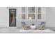 A relaxing patio features two striped chairs, a round table, and a gray exterior at 2021 Trident Maple Ln, Chapel Hill, NC 27517