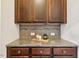 Elegant coffee bar or dry bar with granite countertops and custom cabinets in the dining room at 211 Court Jester Way, Morrisville, NC 27560