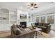 Spacious living room featuring a cozy fireplace, built-in shelving, and ample natural light at 211 Court Jester Way, Morrisville, NC 27560