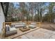 An outdoor patio is staged with a light grey outdoor sofa and lounge chairs at 2607 Nation Ave, Durham, NC 27707