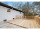Backyard view of the home with a deck, concrete patio and light grey brick at 2607 Nation Ave, Durham, NC 27707