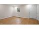 Bright, spacious bedroom with hardwood floors and a door to outside at 2607 Nation Ave, Durham, NC 27707