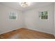 Bright bedroom featuring two windows and attractive hardwood flooring at 2607 Nation Ave, Durham, NC 27707