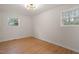 Empty bedroom with wood-look floors, white walls, base trim, and lots of light at 2607 Nation Ave, Durham, NC 27707