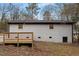 Backyard view of the home featuring the back of the house with a deck and walkout basement at 2607 Nation Ave, Durham, NC 27707