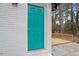 Exterior view of the back of the home with a bright blue door and small wooden deck at 2607 Nation Ave, Durham, NC 27707