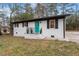 Charming home with a vibrant teal front door and fresh white brick exterior at 2607 Nation Ave, Durham, NC 27707