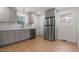 Well lit kitchen features stainless steel appliances, light wood floors, and grey cabinetry at 2607 Nation Ave, Durham, NC 27707