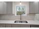 Kitchen sink features stainless fixtures, double basin, and view of the backyard at 2607 Nation Ave, Durham, NC 27707