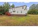 Exterior view of the home featuring a backyard and a red deck, perfect for outdoor gatherings at 270 S Ridge Dr, Garner, NC 27529