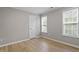 A bright bedroom featuring hardwood floors and two windows offering lots of natural light at 270 S Ridge Dr, Garner, NC 27529