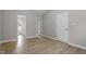 Bedroom with wood flooring and two doorways with views into the hallway and bathroom at 270 S Ridge Dr, Garner, NC 27529