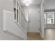 Bright entryway featuring wood-look floors, a staircase, and a white front door with sidelight window at 270 S Ridge Dr, Garner, NC 27529