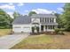 Inviting two-story home featuring a three-car garage, classic black shutters, and landscaped front yard at 270 S Ridge Dr, Garner, NC 27529