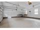 Spacious garage with painted walls, shelving, and tile flooring perfect for storage or a workshop at 270 S Ridge Dr, Garner, NC 27529