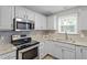 Charming kitchen with stainless steel appliances and tile backsplash at 270 S Ridge Dr, Garner, NC 27529
