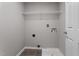 Functional laundry room with tile flooring, storage shelf, and utility connections at 270 S Ridge Dr, Garner, NC 27529