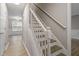 Staircase with natural wood steps and a white railing, leading to the upper level at 270 S Ridge Dr, Garner, NC 27529