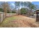 Fenced backyard with mature trees and dormant grass at 3 Duxford Ct, Durham, NC 27703