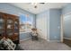 Charming bedroom with a decorative rocking chair, large window, and built-in storage, all enhanced by soft blue walls at 303 Bella Sq, Smithfield, NC 27577