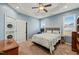 Bedroom with a ceiling fan, natural light, and a stacked washer/dryer near the closet at 303 Bella Sq, Smithfield, NC 27577