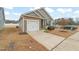 Exterior featuring stone and siding, attached garage and green landscaping at 303 Bella Sq, Smithfield, NC 27577