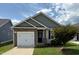 Charming single-story home featuring stone accents, a one-car garage, and a well-maintained lawn at 303 Bella Sq, Smithfield, NC 27577