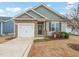 Charming single Gathering home featuring a one-car garage and meticulously landscaped front yard at 303 Bella Sq, Smithfield, NC 27577