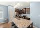 Well-equipped kitchen with granite island, stainless steel appliances and dark wood cabinets at 303 Bella Sq, Smithfield, NC 27577