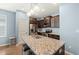 Modern kitchen equipped with stainless steel appliances, dark cabinetry, and a granite-topped island with bar stool seating at 303 Bella Sq, Smithfield, NC 27577