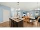 Open kitchen features an island with granite counters, stainless appliances, and a dining area at 303 Bella Sq, Smithfield, NC 27577