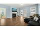 Living room with a fireplace and TV on top, with hardwood floors, and natural light at 303 Bella Sq, Smithfield, NC 27577